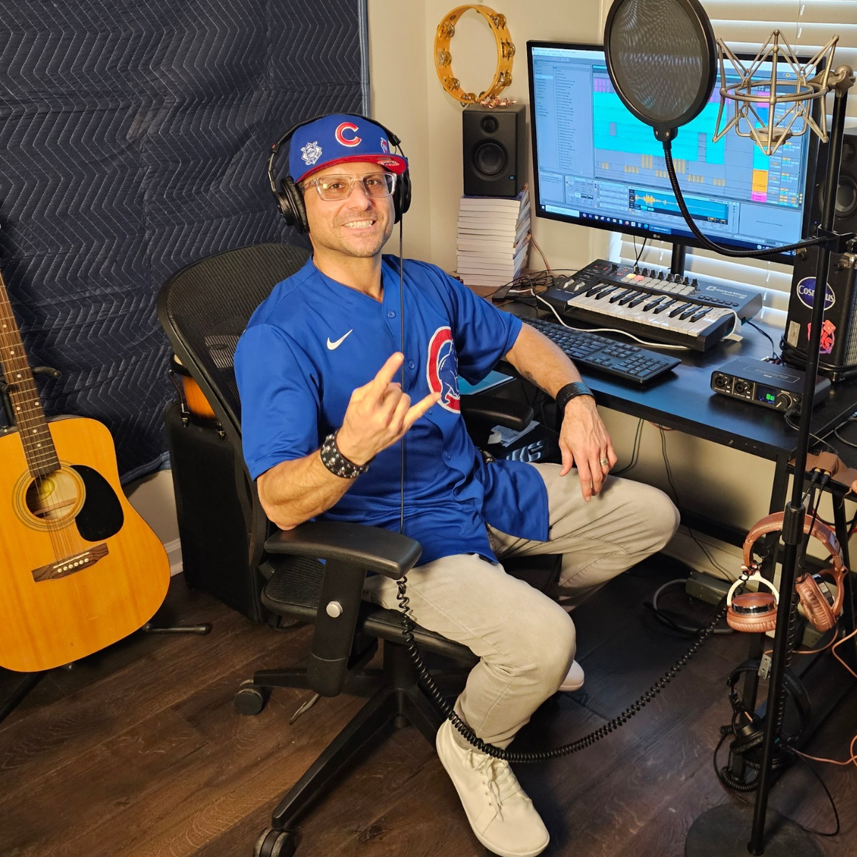 Cosmicus in Chicago Cubs Jersey at music production studio in clear glasses rocking out