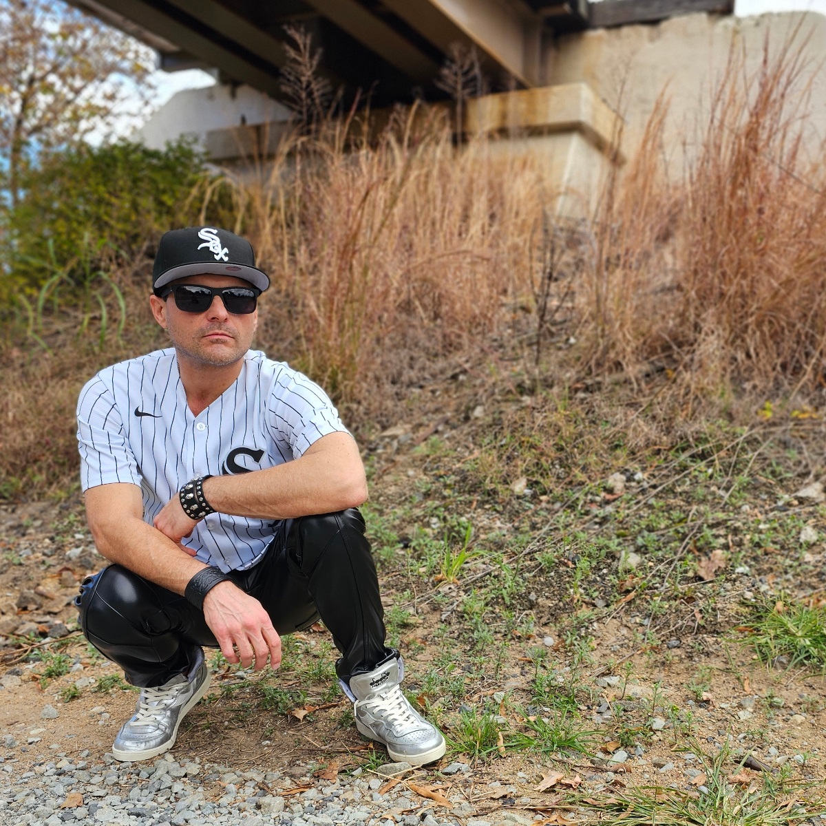 Cosmicus in White Sox Jersey and faux leather punk pants with shiny diadora high top sneakers in city