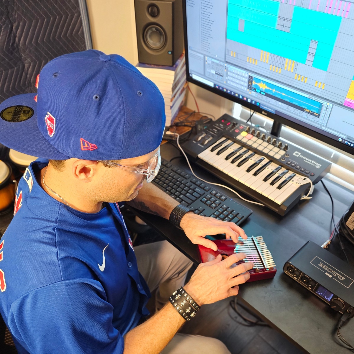 Cosmicus playing kalimba in music studio